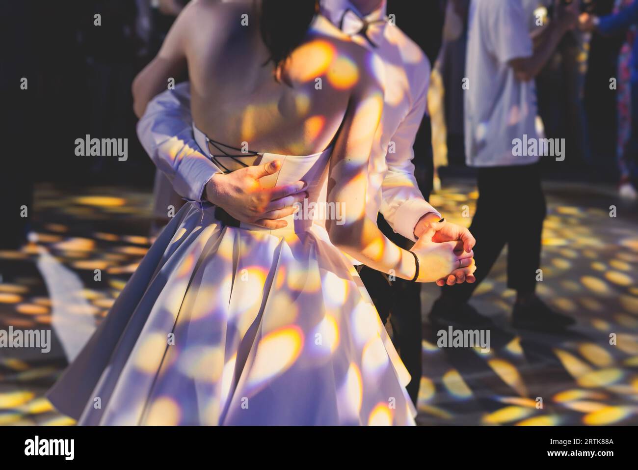 High school graduates dancing waltz and classical ball dance in dresses
