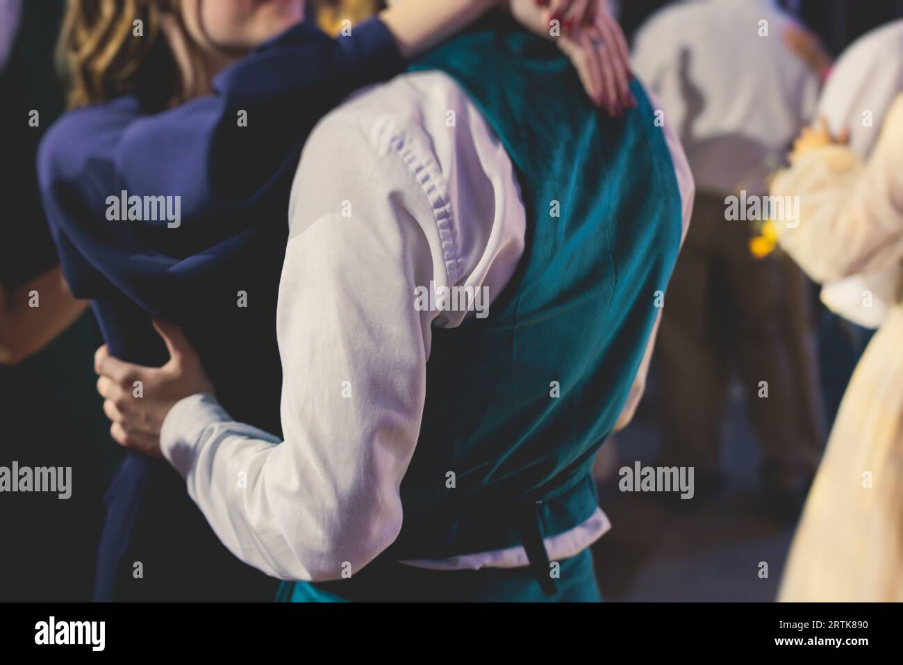 High school graduates dancing waltz and classical ball dance in dresses