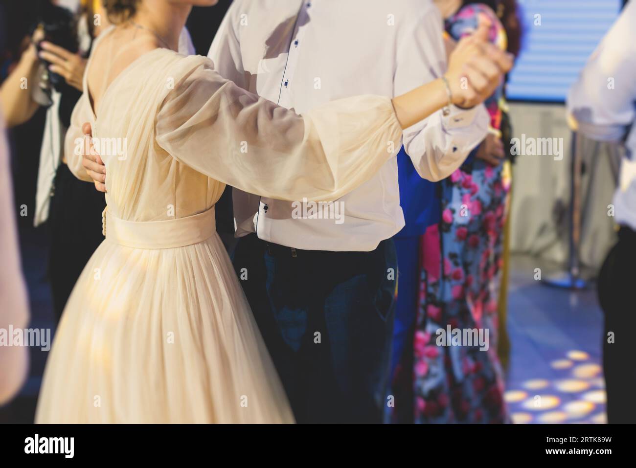 High school graduates dancing waltz and classical ball dance in dresses