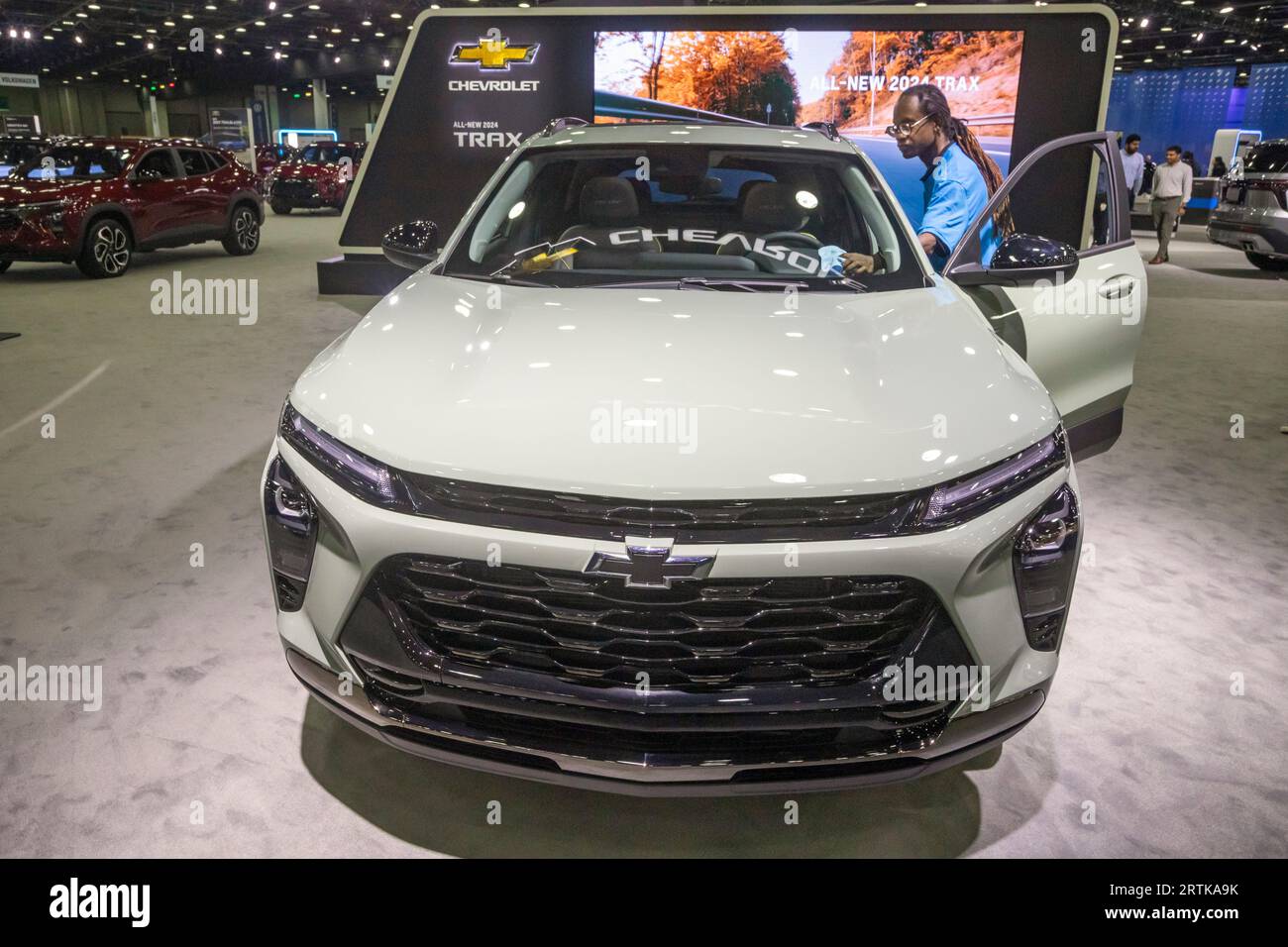 Detroit, Michigan, USA. 13th Sep, 2023. A worker polishes a 2024 Chevrolet Trax on display at the North American International Auto Show. Credit: Jim West/Alamy Live News Stock Photo