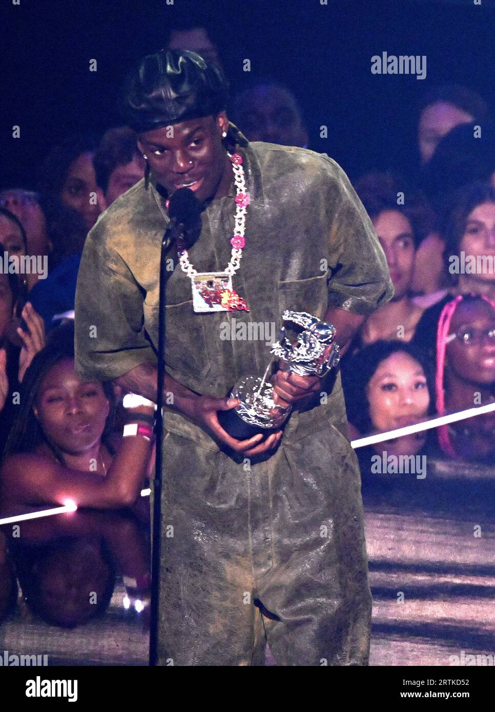 Newark, USA. 12th Sep, 2023. Rema accepts the Best Afrobeats award for 'Calm Down' onstage, presented by Tiffany Haddish at the 2023 MTV Video Music Awards on September 12, 2023 in Newark, New Jersey. PhotoL Jeremy Smith/imageSPACE Credit: Imagespace/Alamy Live News Stock Photo