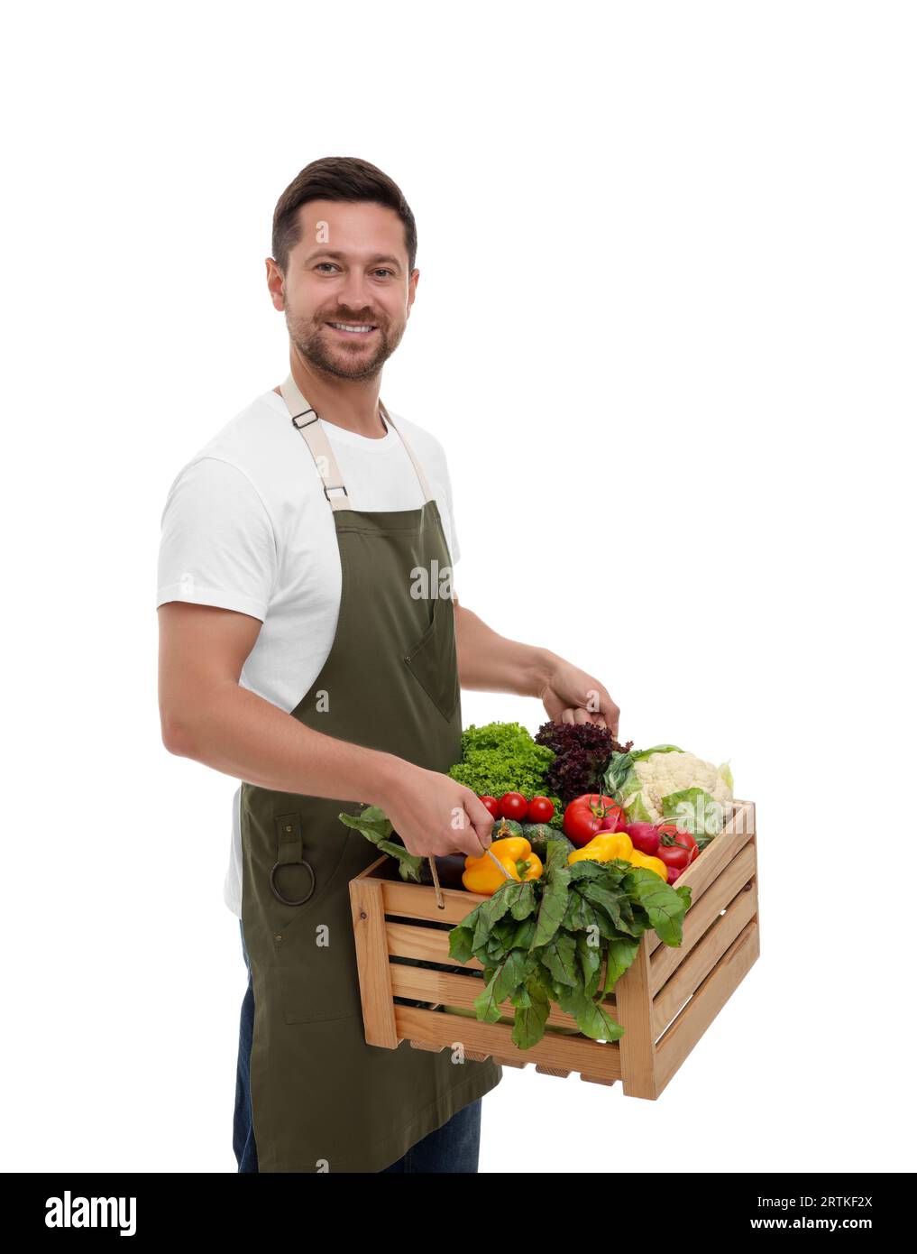 Harvesting season. Happy farmer holding wooden crate with vegetables on ...