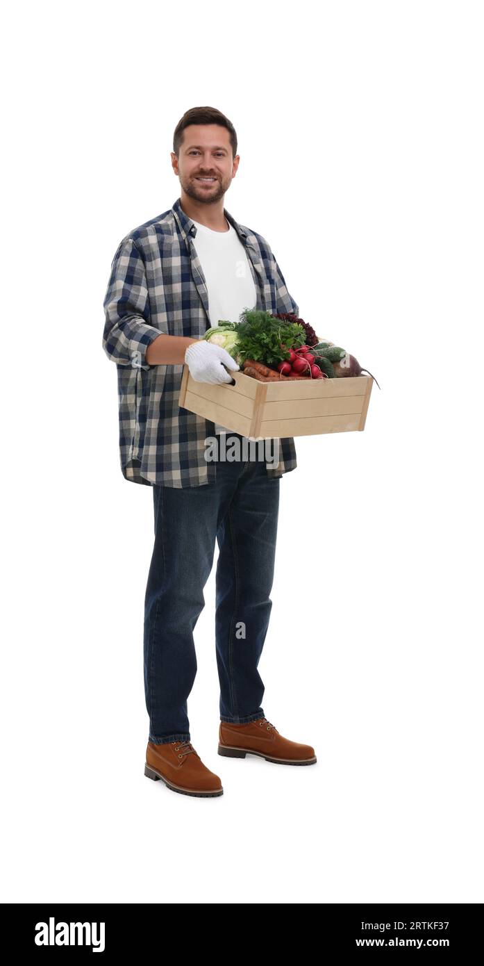 Harvesting season. Happy farmer holding wooden crate with vegetables on ...