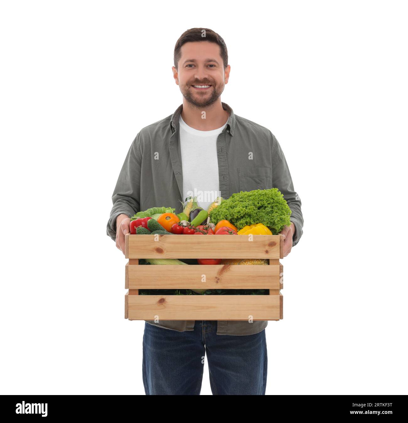Harvesting season. Happy farmer holding wooden crate with vegetables on ...