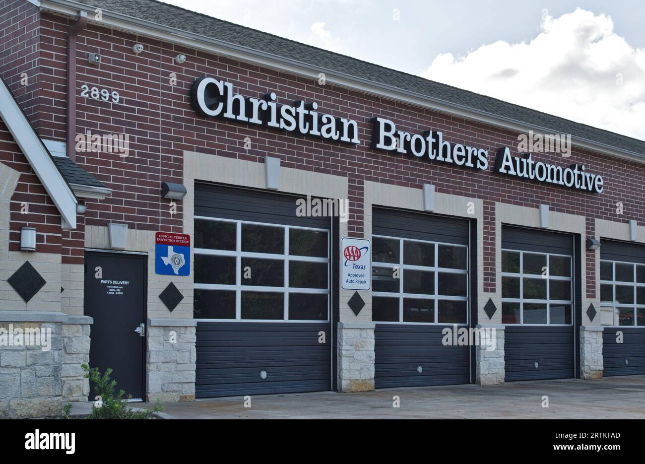 Houston, Texas USA 07-30-2023: Christian Brothers Automotive workshop exterior and garage doors in Houston, TX. Auto repair business chain est. 1982. Stock Photo