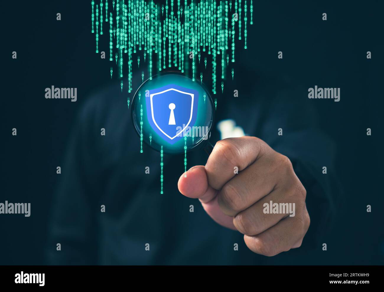 Hacker standing holding a magnifying glass with data protection sign on dark background. Concept of information security in internet networks and espi Stock Photo