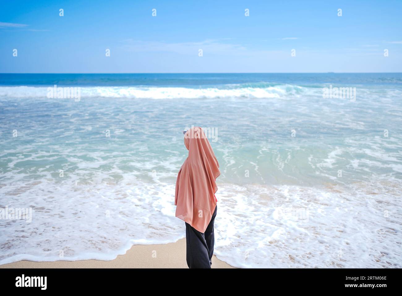 women in hijab are enjoying on the beach and playing in the sea water ...