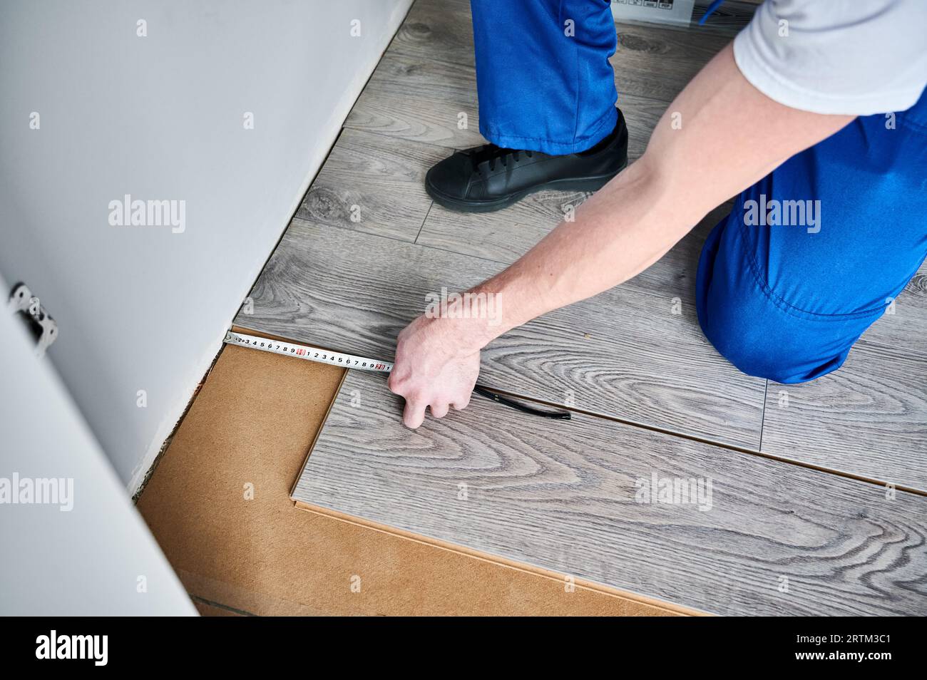 Measuring Distance Using Hand Construction worker measuring distance using tape measure building hi ...