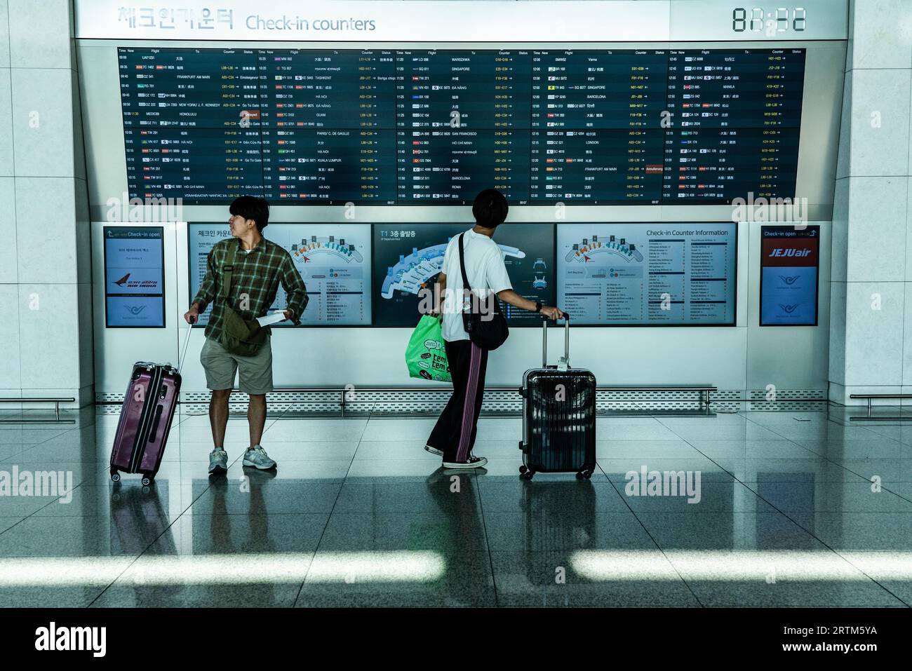 Incheon, South Korea. 14th Sep, 2023. Tourists with suitcases walk in ...