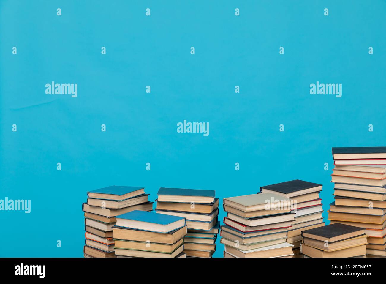 science of knowledge reading many books in stacks in the library on a ...