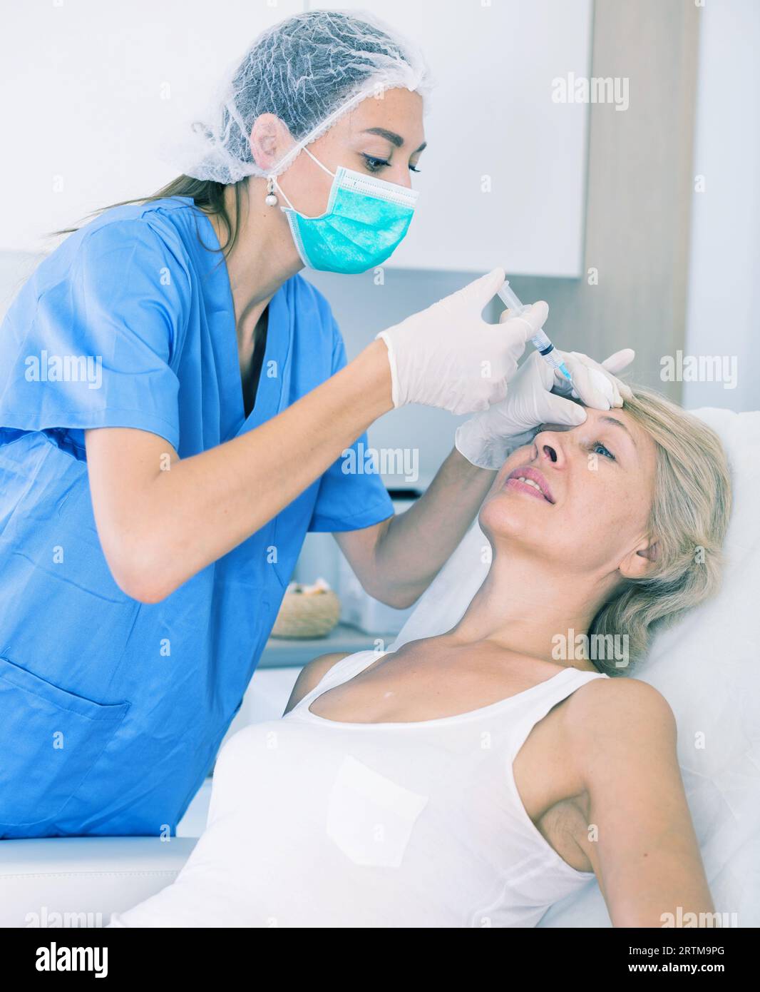 Mature woman receiving injections hi-res stock photography and images ...