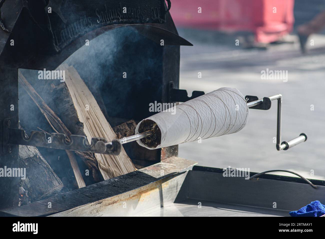 Initial stage of preparation of a tree cake, Lithuanian šakotis, Polish sękacz, Belarusian bankucha, German baumkuchen cooked over an open fire Stock Photo