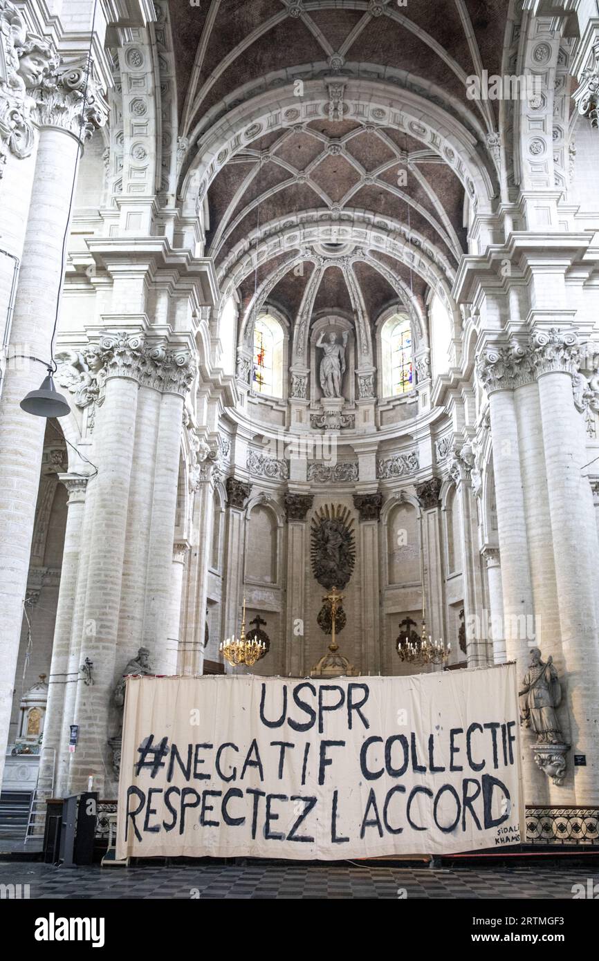 Banner in Beguinage catholic church, Brussels, Belgium. Union des sans-papier pour la Regularisation Stock Photo