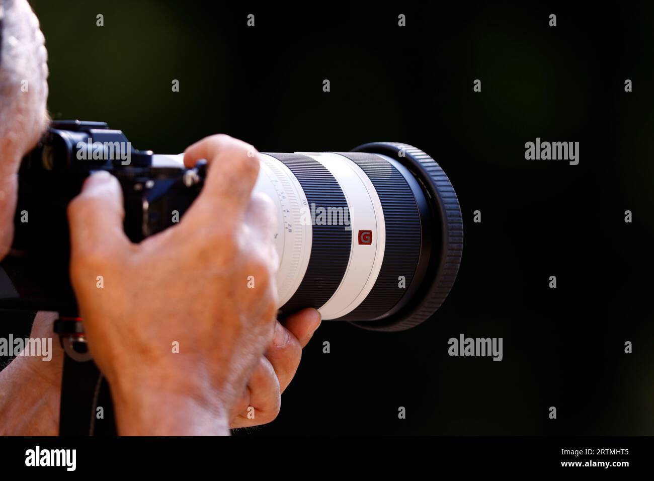 Photographer working with a telephoto lens. France. Stock Photo