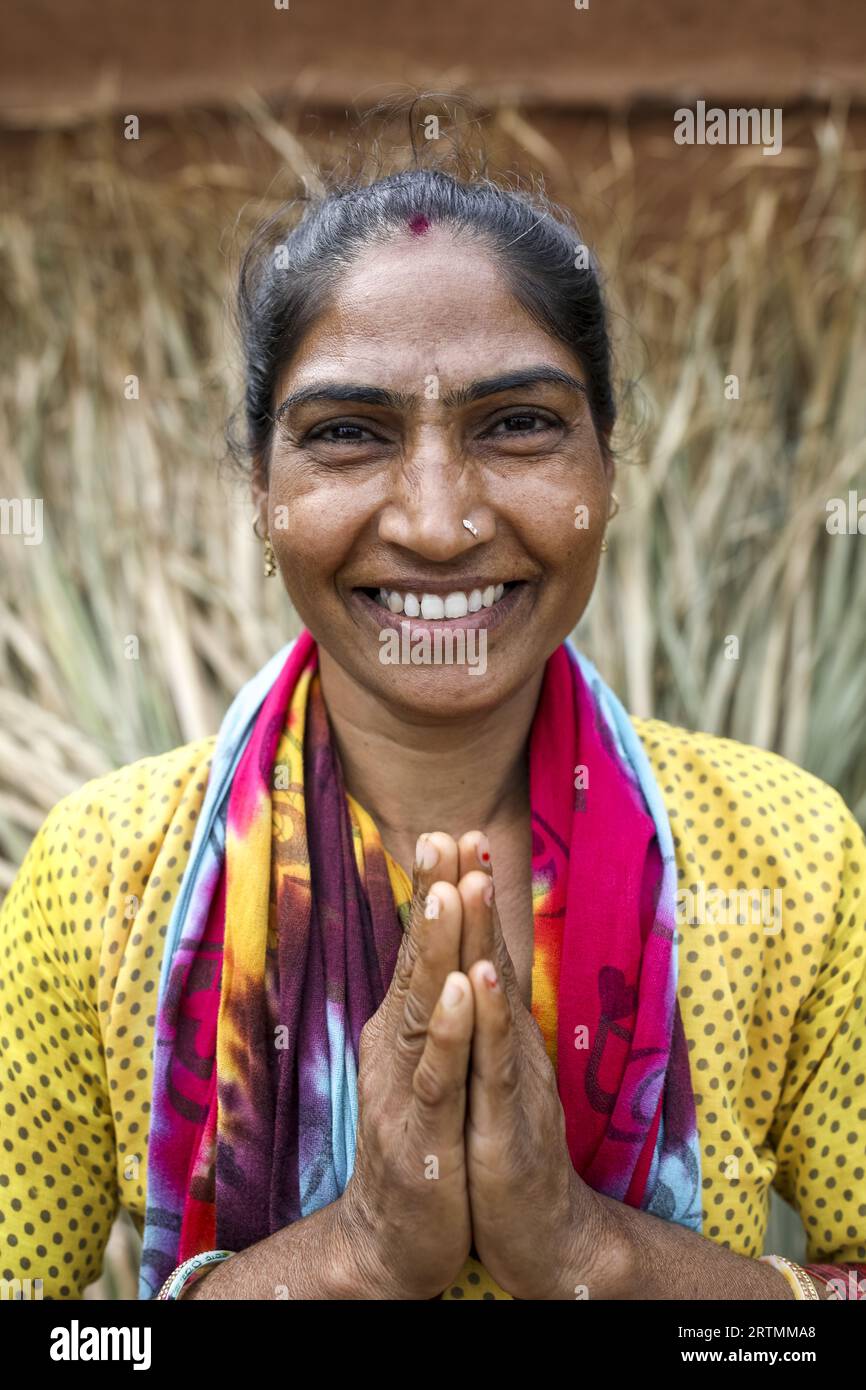 Smiling Adivasi woman joining hands in Dediapada, Gujarat, India Stock Photo