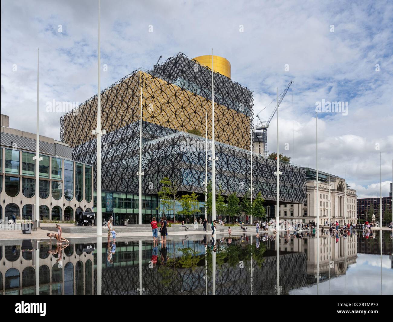 Centenary Square, Birmingham, UK; reflections of the Library of Birmingham and Baskerville House in a shallow ornamental pool. Stock Photo