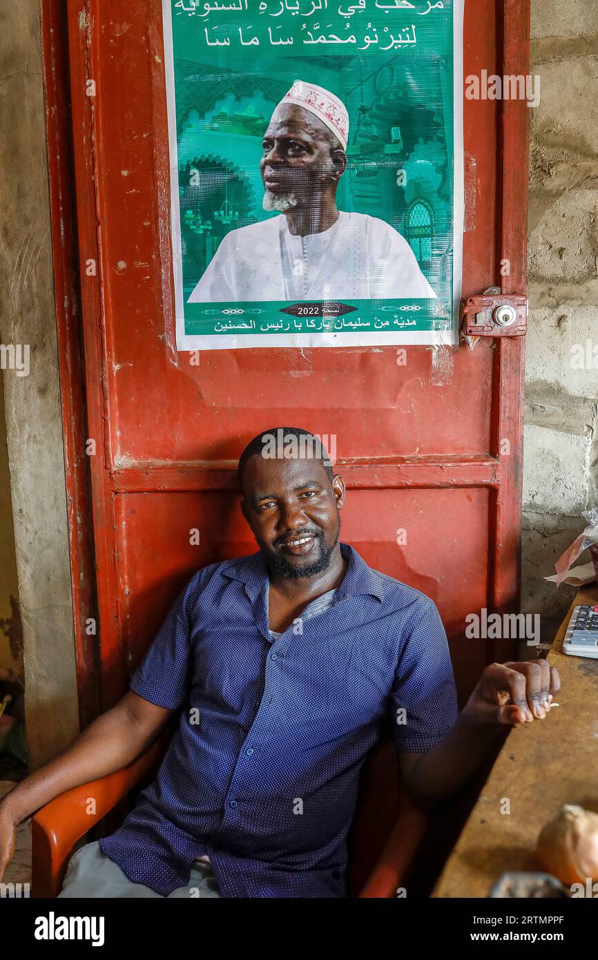 Shopkeeper displaying a picture of a muslim spiritual leader in Fatick, Senegal Stock Photo