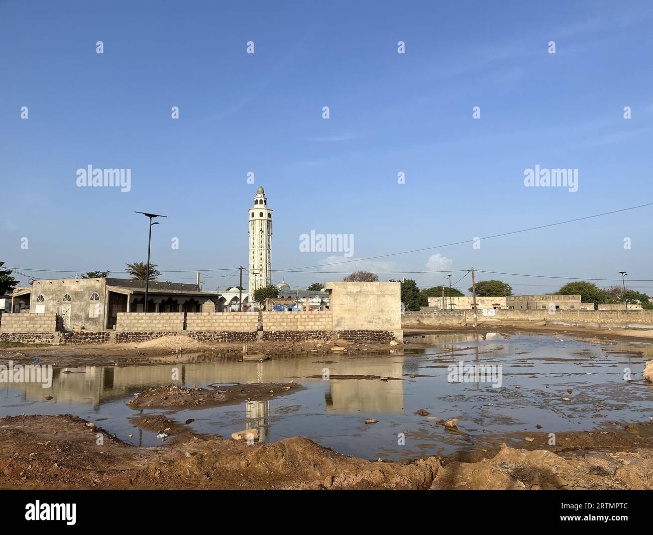 Waterlogged ground next to a mosque in Ndayane, Senegal Stock Photo