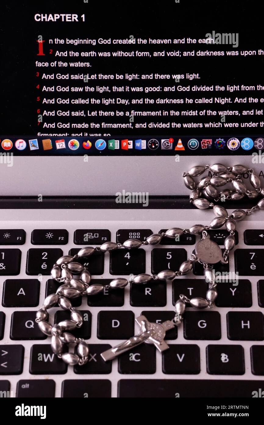 Digital Bible and catholic rosary.   Reading the bible on a laptop. Stock Photo
