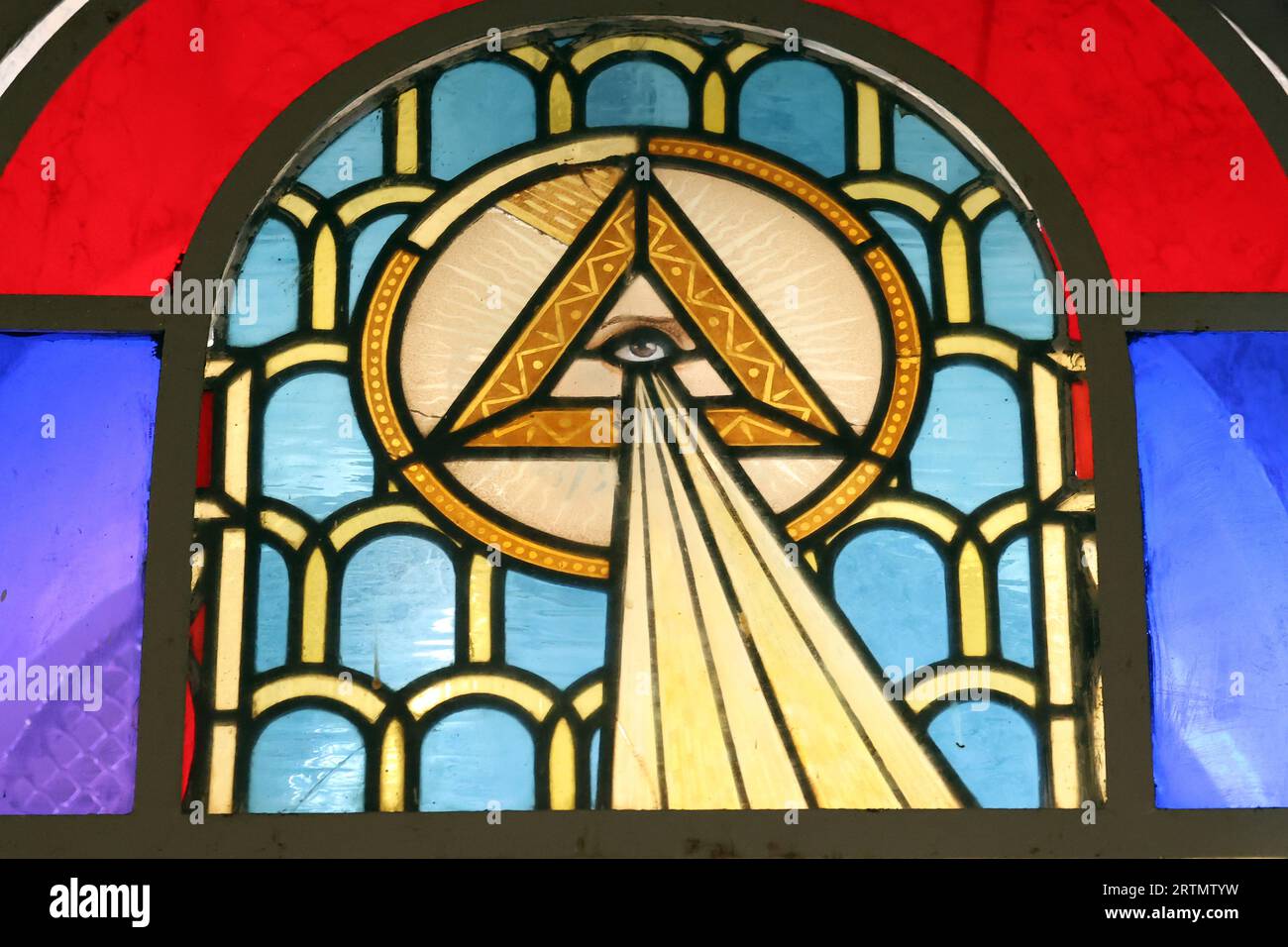 All-Seeing Eye of God, or the Eye of Providence. A triangle surrounded by rays of light or glory represents the divine providence. God is watching us. Stock Photo