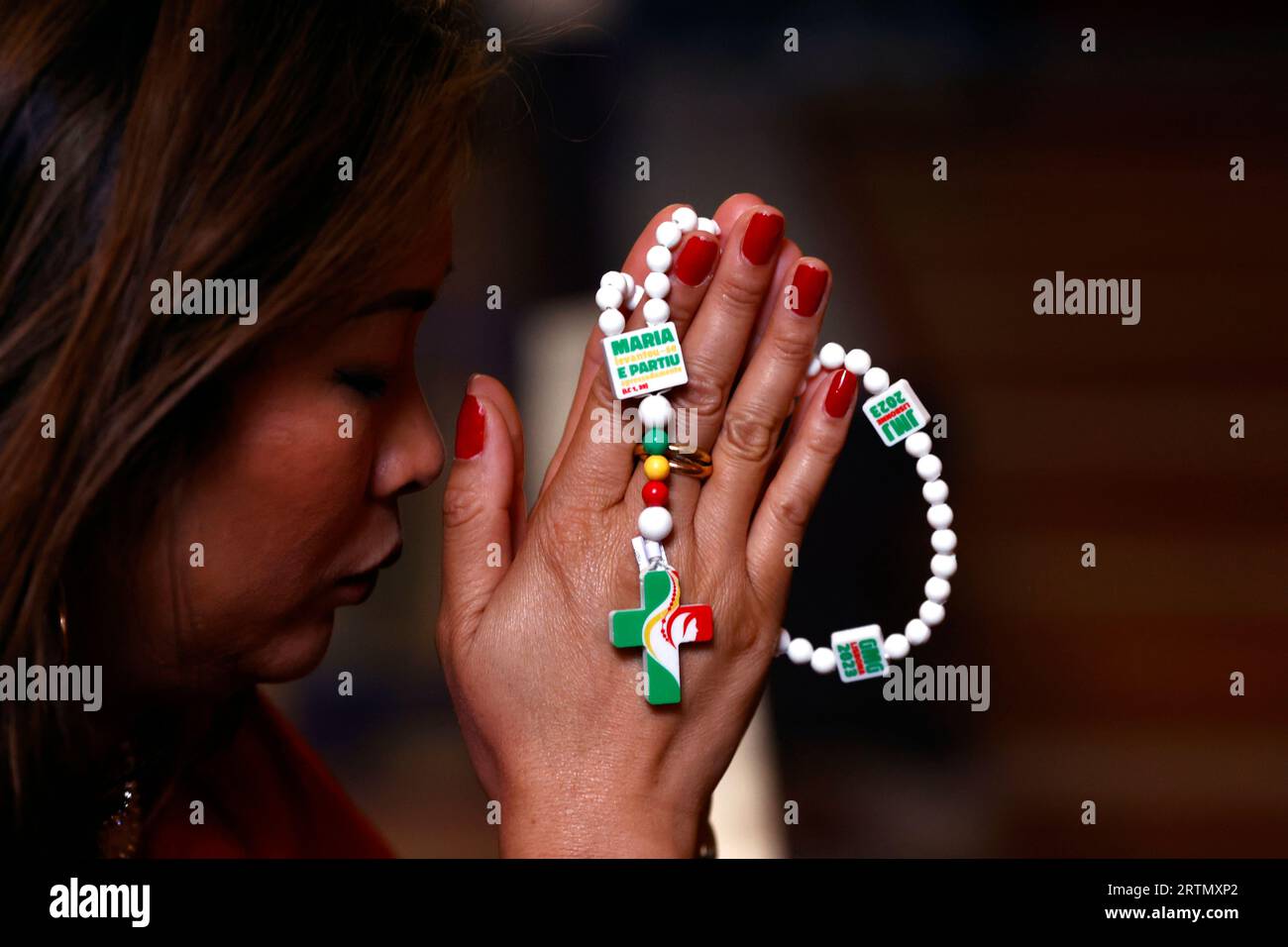 WYD World Youth Day 2023 Lisbon. Woman praying the Rosary. Portugal. Porto. Portugal Stock Photo