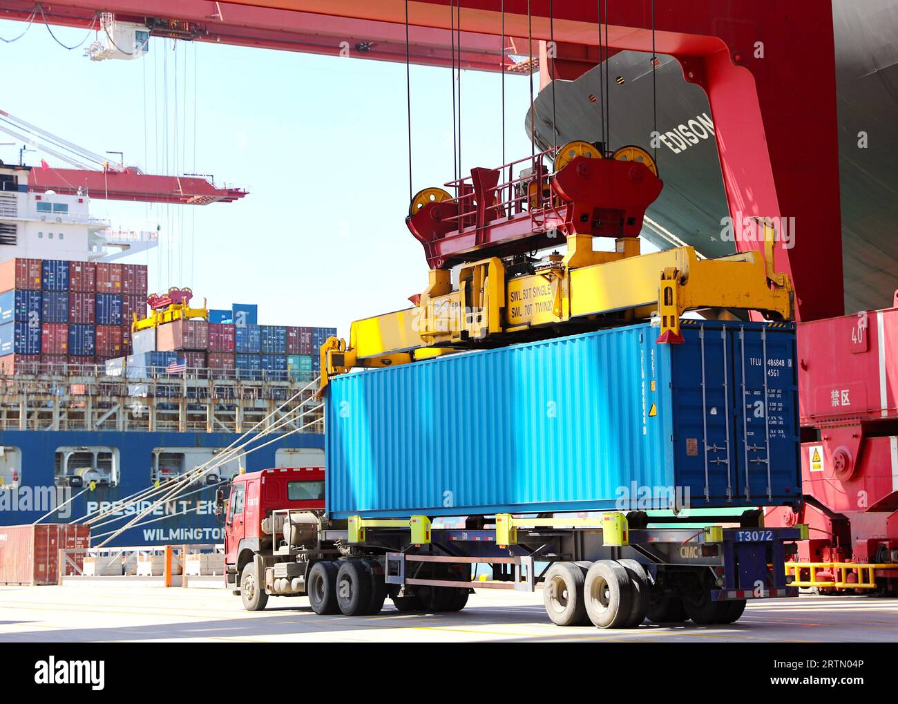 A container truck loads goods at the Qingdao section of the Shandong ...