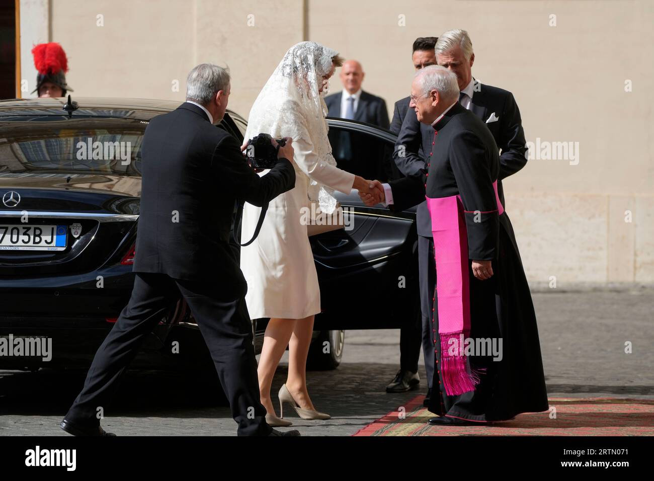 Belgium's Queen Mathilde, second from left, shakes hands with Monsignor ...