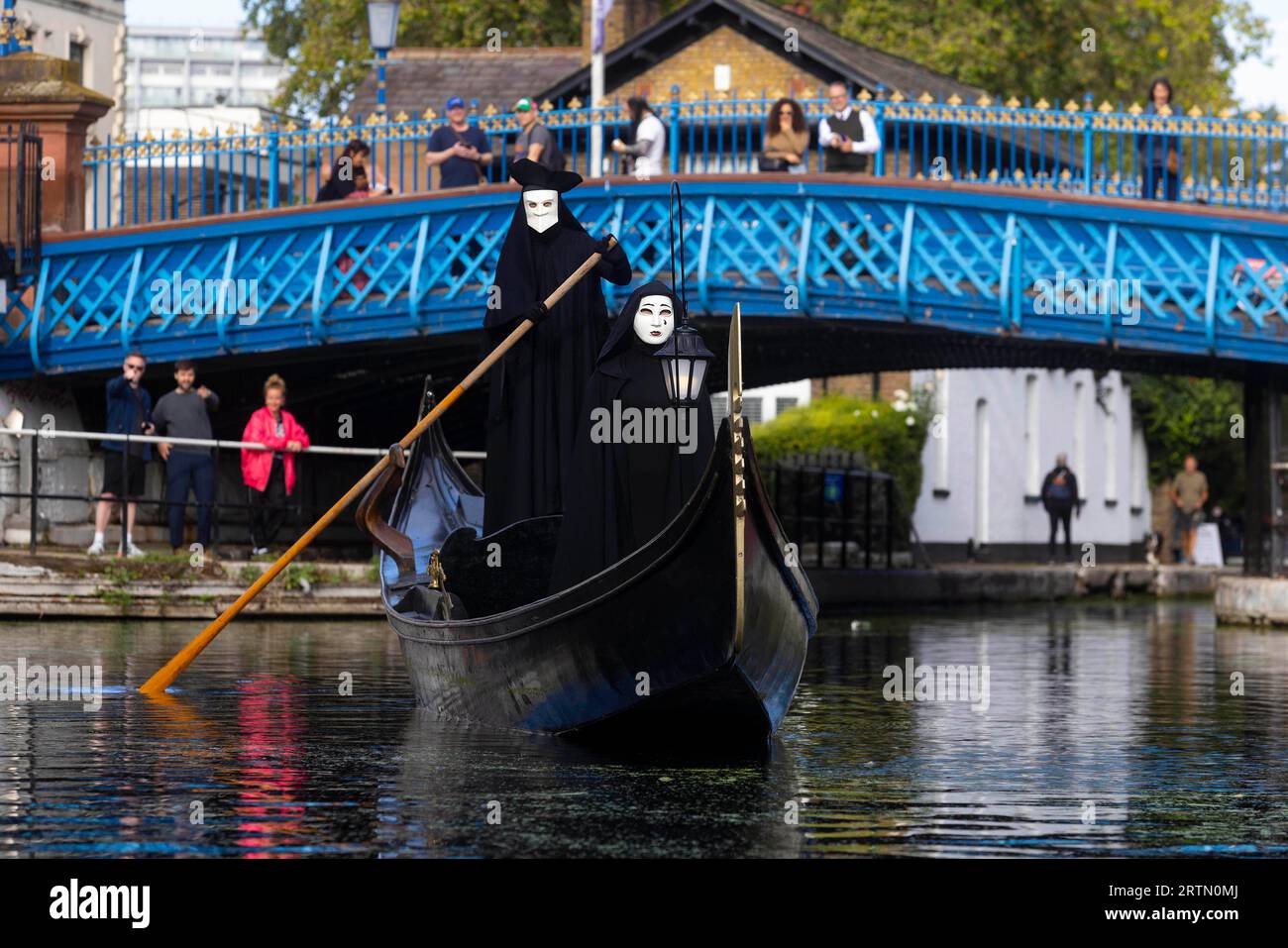 EDITORIAL USE ONLY Two cloaked figures operate a traditional Venetian Gondola in Little Venice to celebrate the launch of the new 20th Century Studios film, A Haunting in Venice. Picture date: Thursday September 14, 2023. Stock Photo