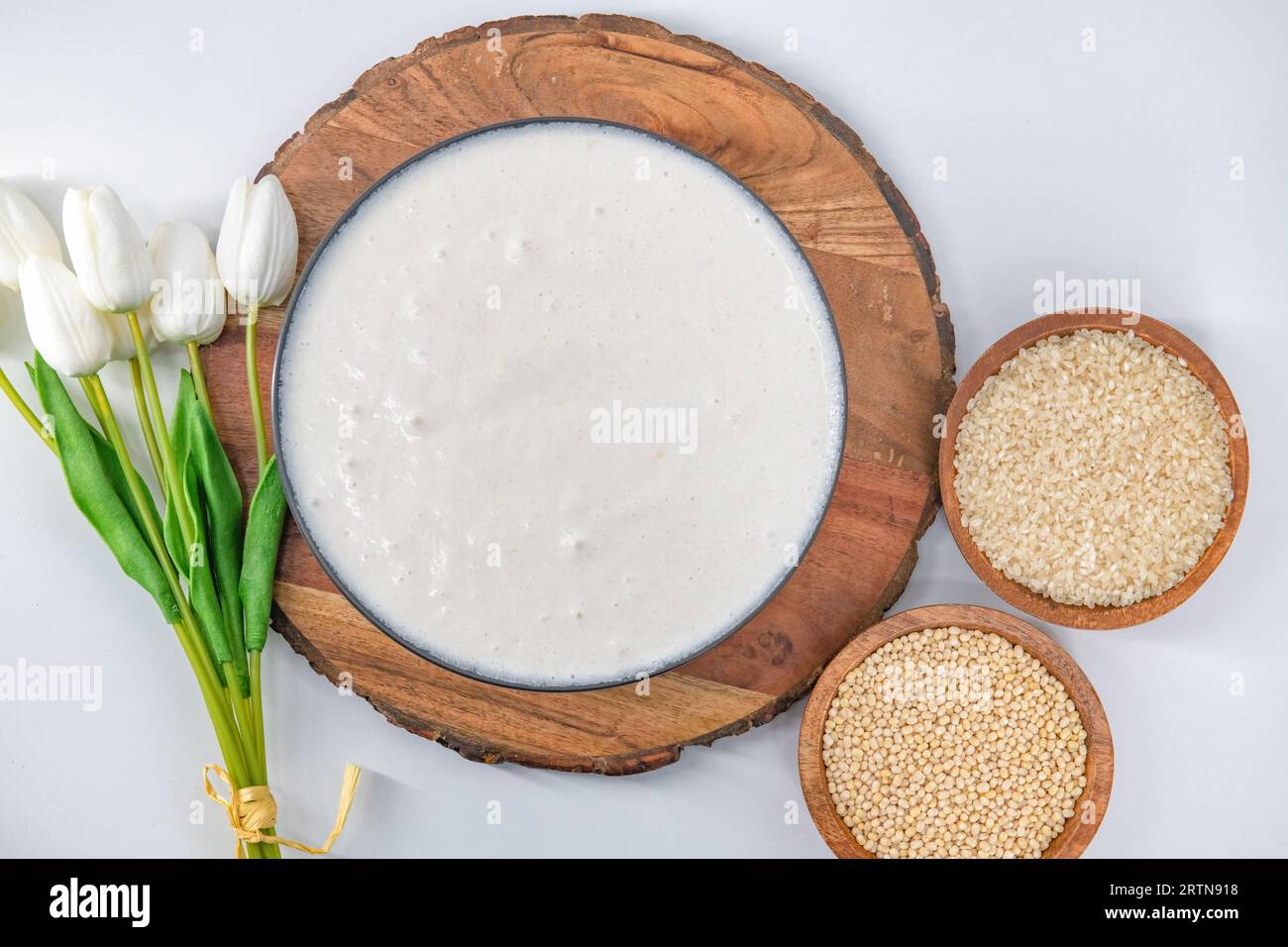 Selective focused image of fermented batter for idli and dosa in an isolated background. Idly and dosa batter in a bowl for fermentation. Stock Photo