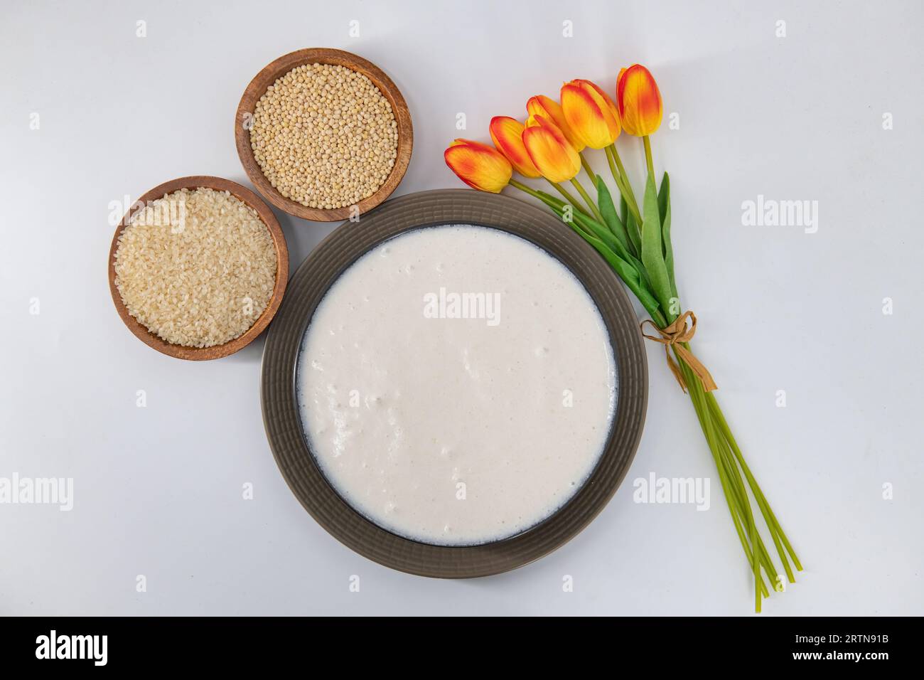 Selective focused image of fermented batter for idli and dosa in an isolated background. Idly and dosa batter in a bowl for fermentation. Stock Photo