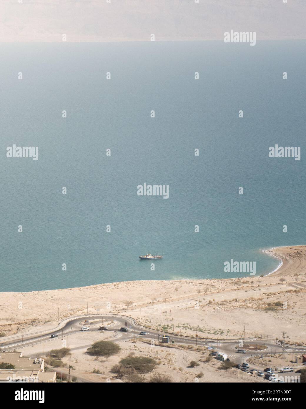 An aerial view of a boat on the surface of the Dead Sea in Israel, adjacent to the Ein Gedi beach Stock Photo
