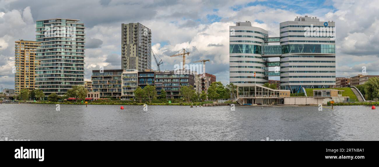 Amsterdam, The Netherlands, 08.08.2023, Waterfront of Amstel at Park Somerlust, View of the modern apartment tower Haut and office complex of the muni Stock Photo