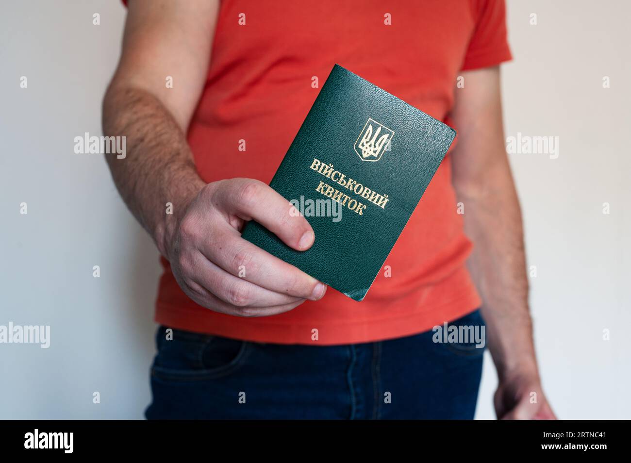 Translation: 'military id'. Civil man holding ukrainian military id. Soldier, mobilization, veteran, rookie, document Stock Photo