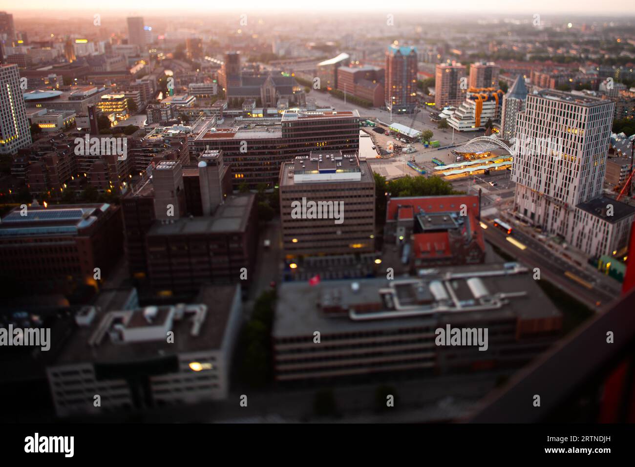 Enjoying the sunset in Rotterdam from a penthouse at the Red Apple building located in the Wijnhaven. Fake Miniature style shot with tilt-shift lens. Stock Photo