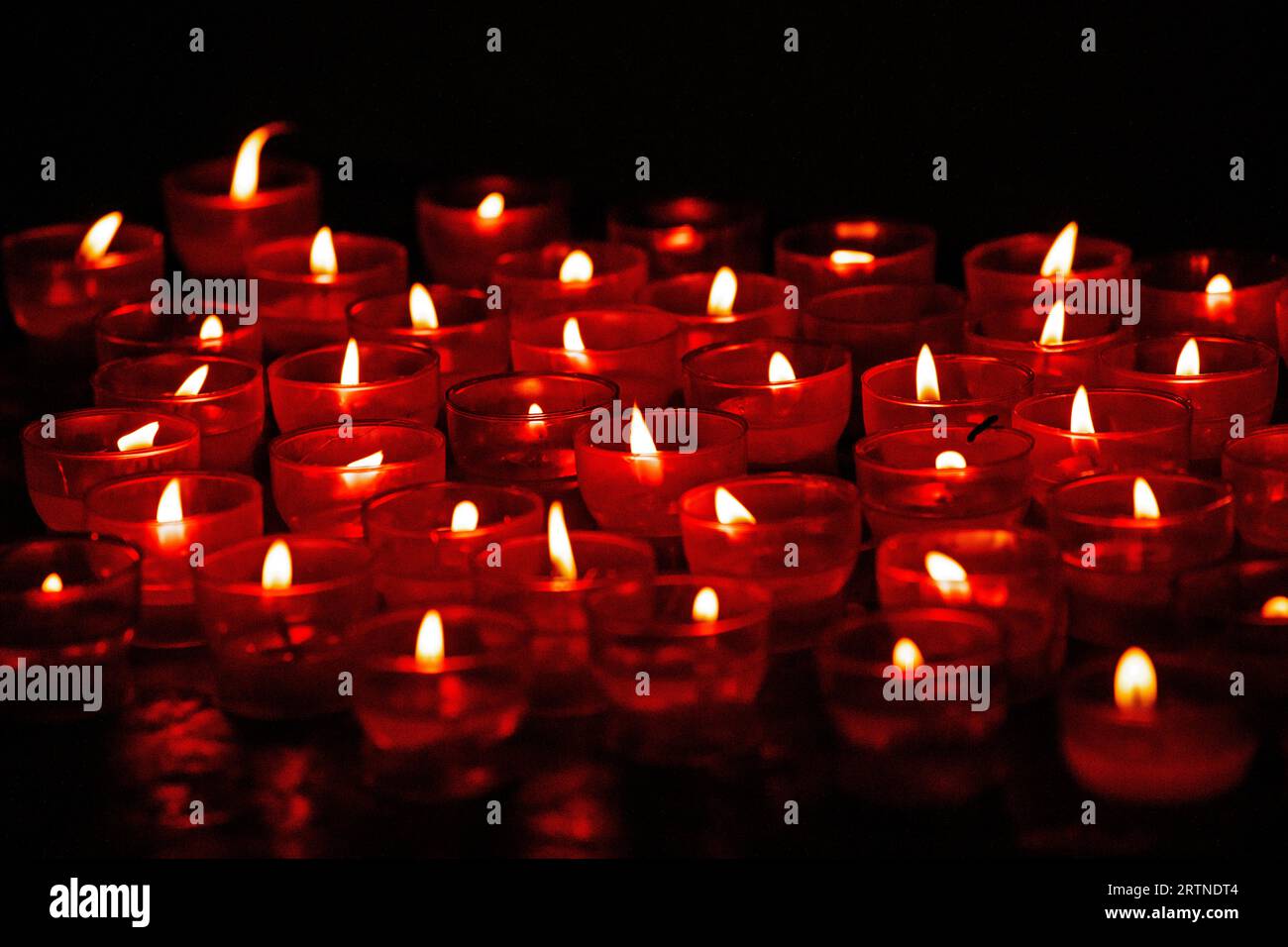 red background of burning candles in red lamps. Fire Festival, Veterans Memorial Day Stock Photo