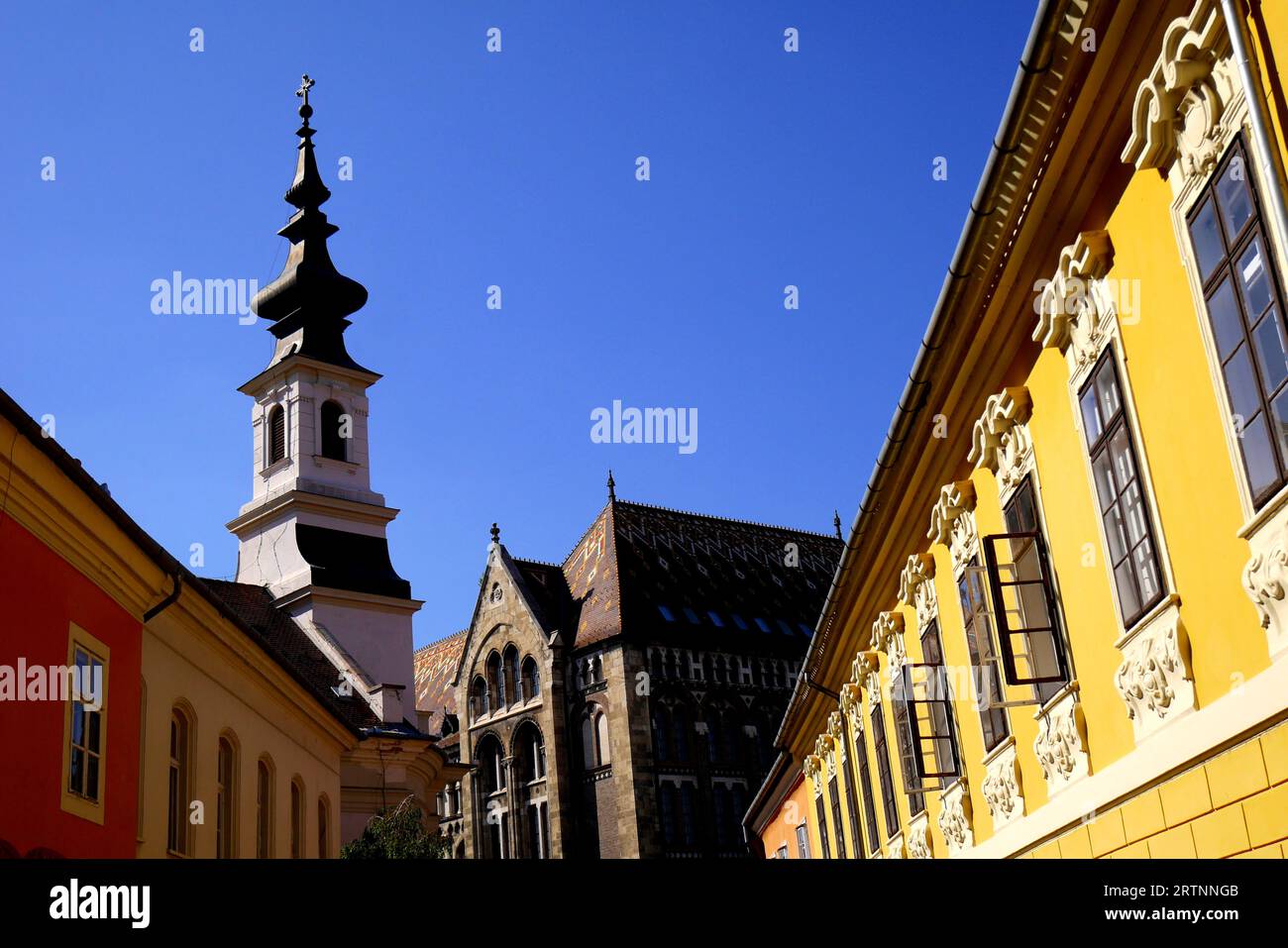 Colourful houses and the Evangelical Church in Becsi Kapu ter,  Becsi Kapu Square, Castle District, Budapest, Hungary Stock Photo
