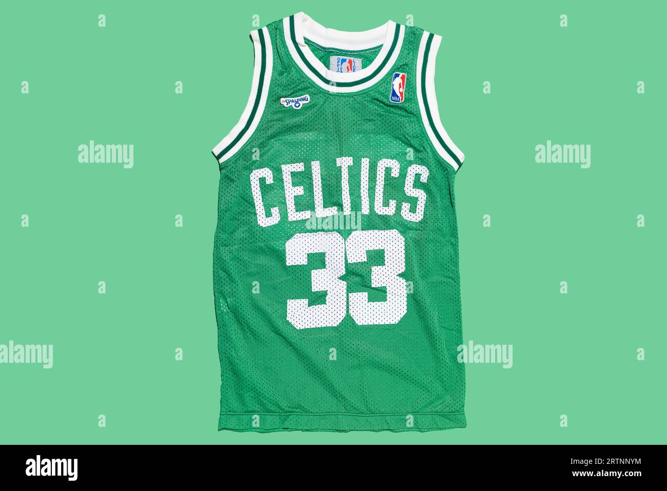 Boston Celtics retro green basketball jersey with Larry Bird's number 33, on a green background. Basketball, spalding, sports equipment and basketball Stock Photo