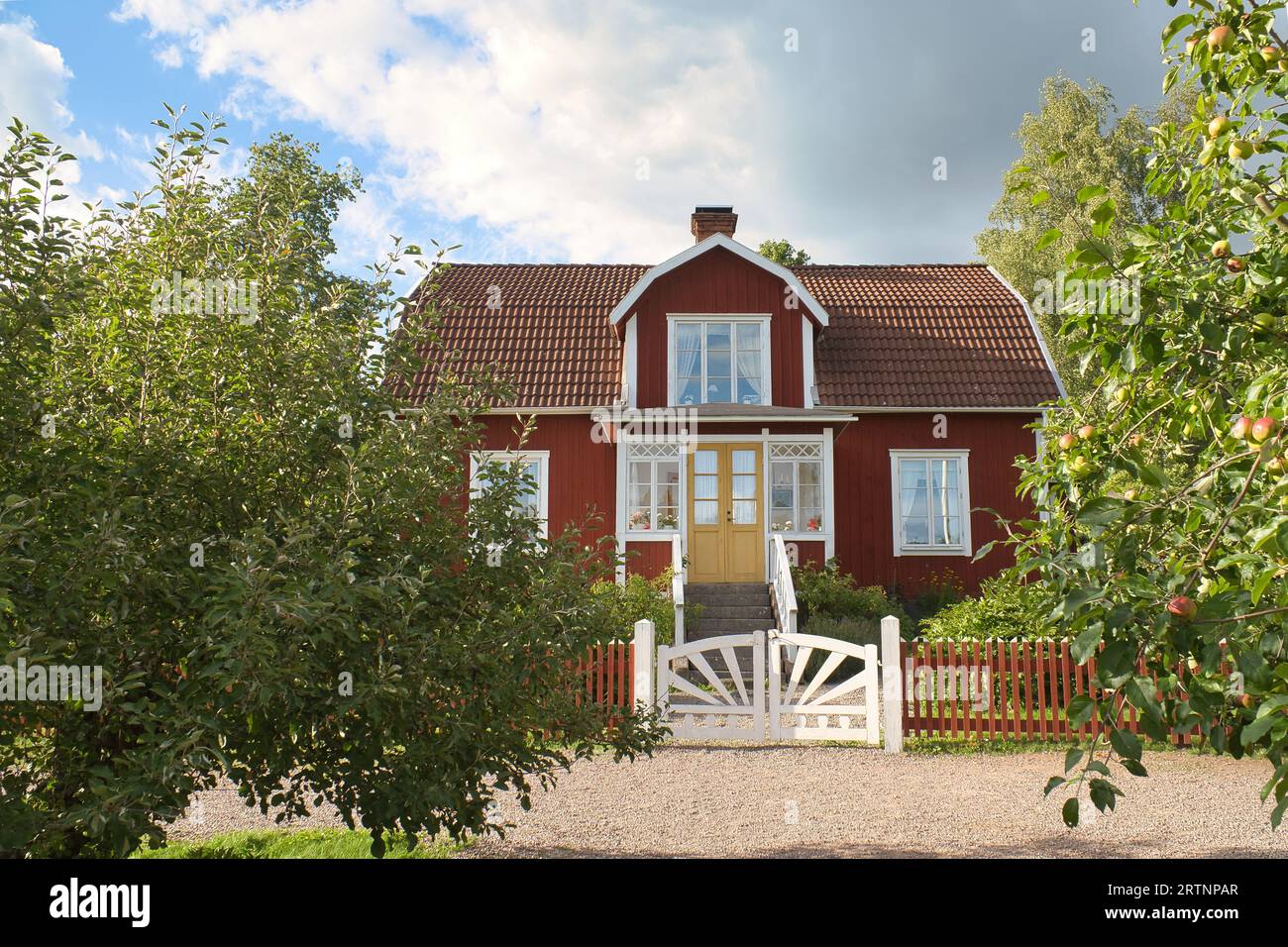 a typical red and white swedish house in smalland. White garden gate ...