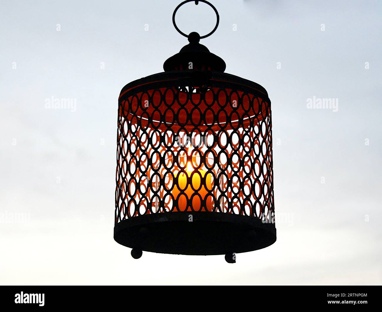 Ornamental Garden Lantern with burning candle Stock Photo