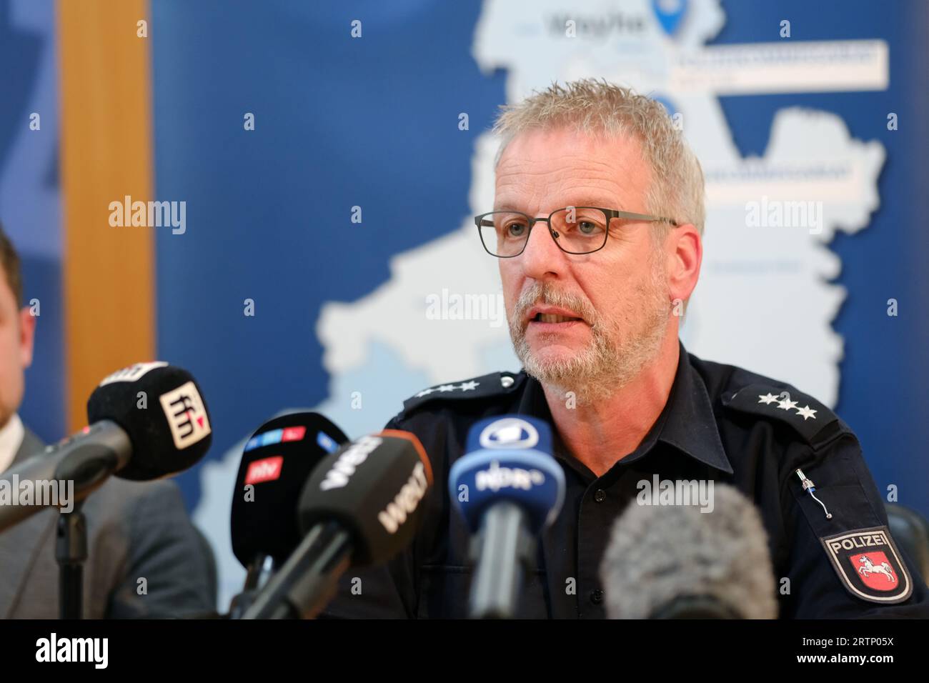 Twistringen, Germany. 14th Sep, 2023. Thomas Gissing, press spokesman for the Diepholz Police Inspectorate, speaks at a press conference at the town hall in Twistringen. After the death of a 17-year-old inline skater and an attack on a 30-year-old woman in the Diepholz district of Lower Saxony, there are still no clues to the background or a motive for the crime, according to the public prosecutor's office. A 42-year-old German suspect was caught on Wednesday evening. Credit: Markus Hibbeler/dpa/Alamy Live News Stock Photo