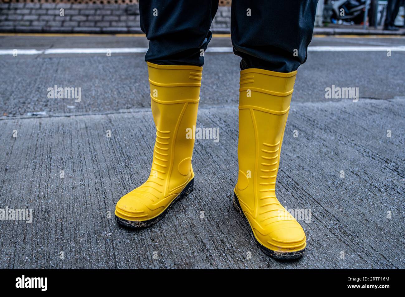 Hong Kong, Hong Kong. 14th Sep, 2023. A man shows off his yellow rain ...