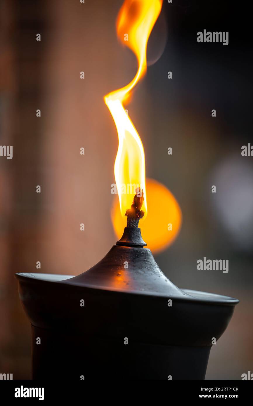 Big orange flame burning on top of oil lamp beautiful outdoors night