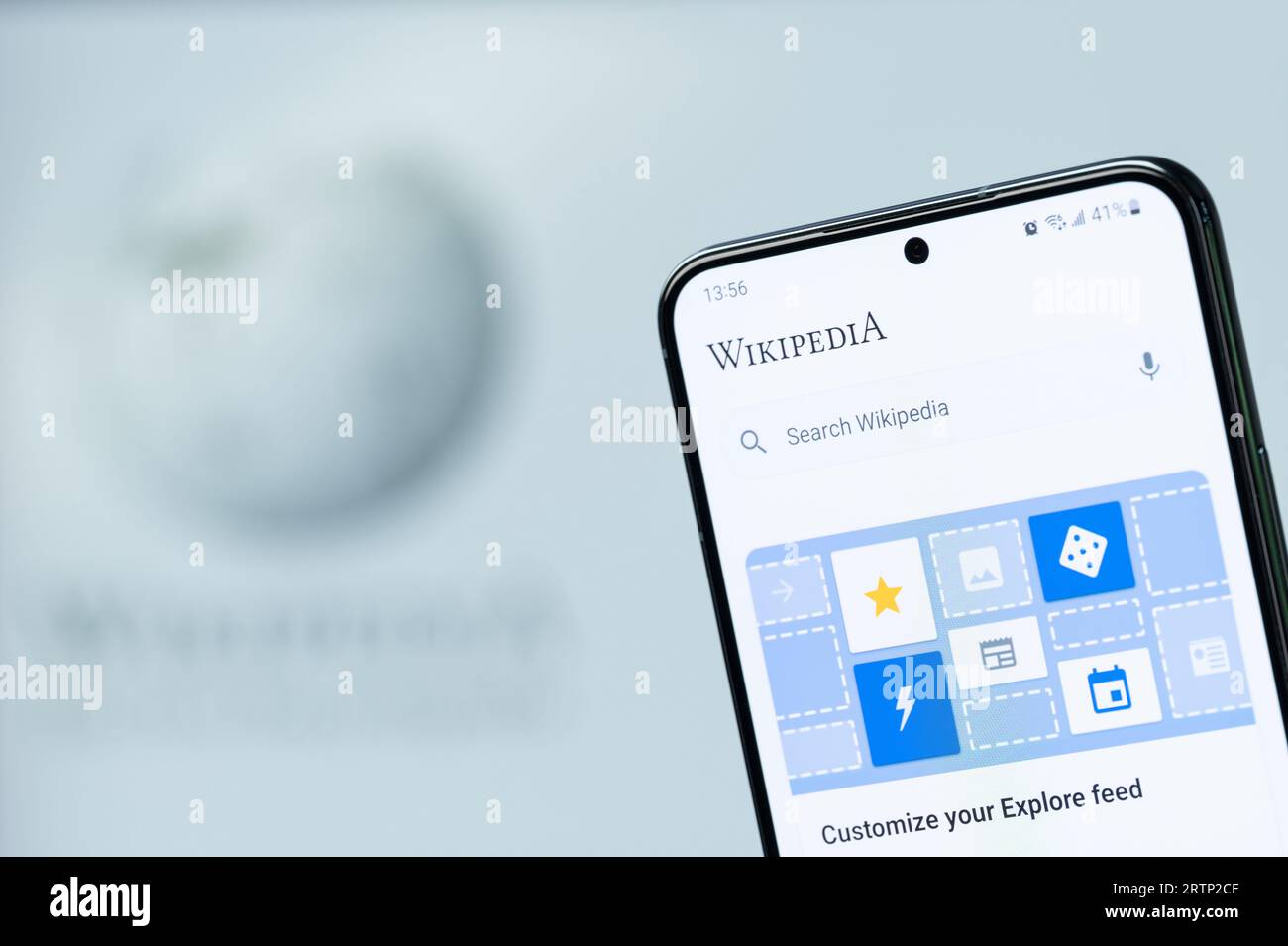 New York, USA - August 20, 2023: Search article on wikipedia app on smartphone display close up with blurred logo background Stock Photo