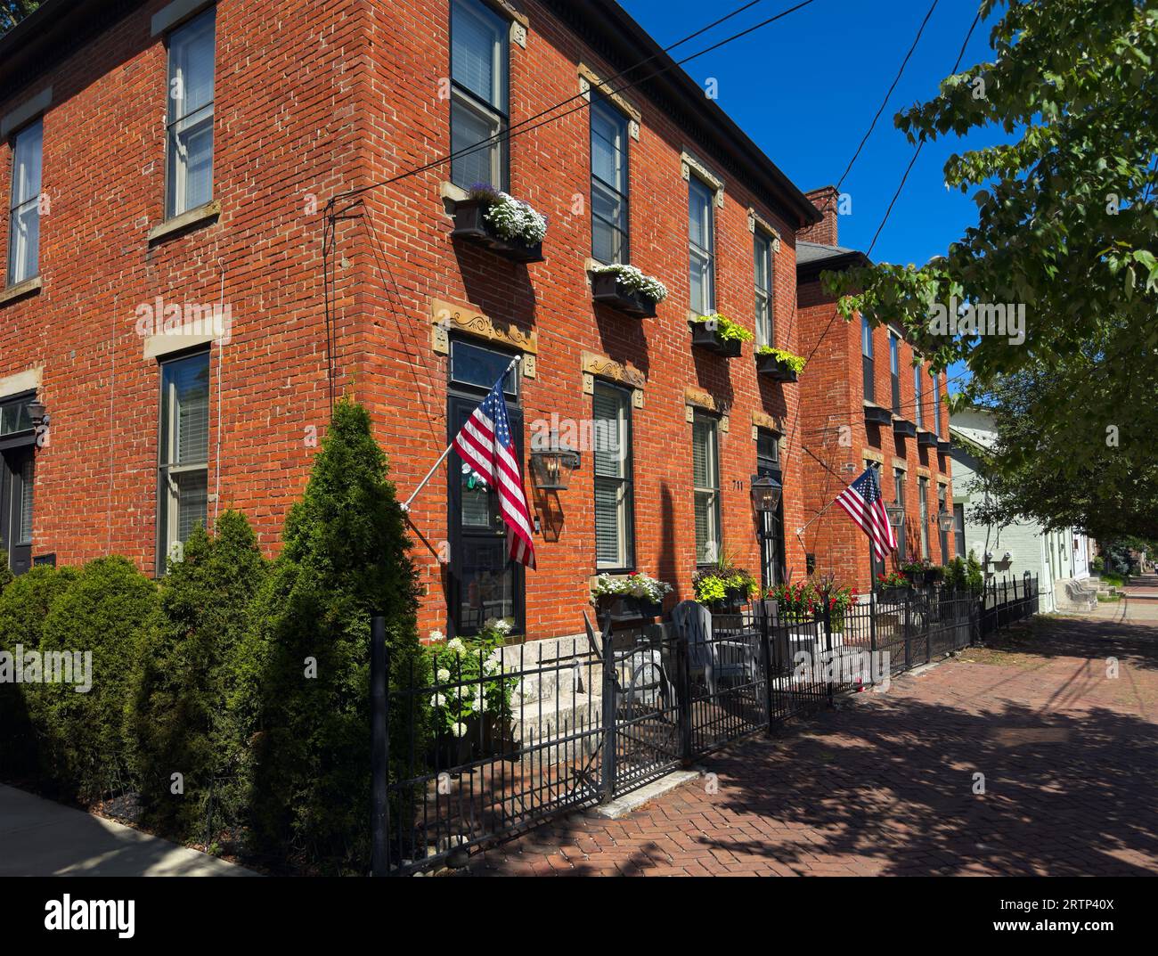 Old residential buildings along brick sidewalks maintain an old world