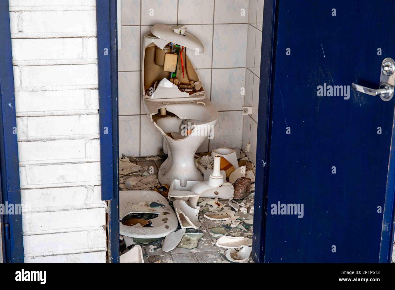 Broken toilet seat in abandoned and vandalized factory building in Paimio, Finland Stock Photo