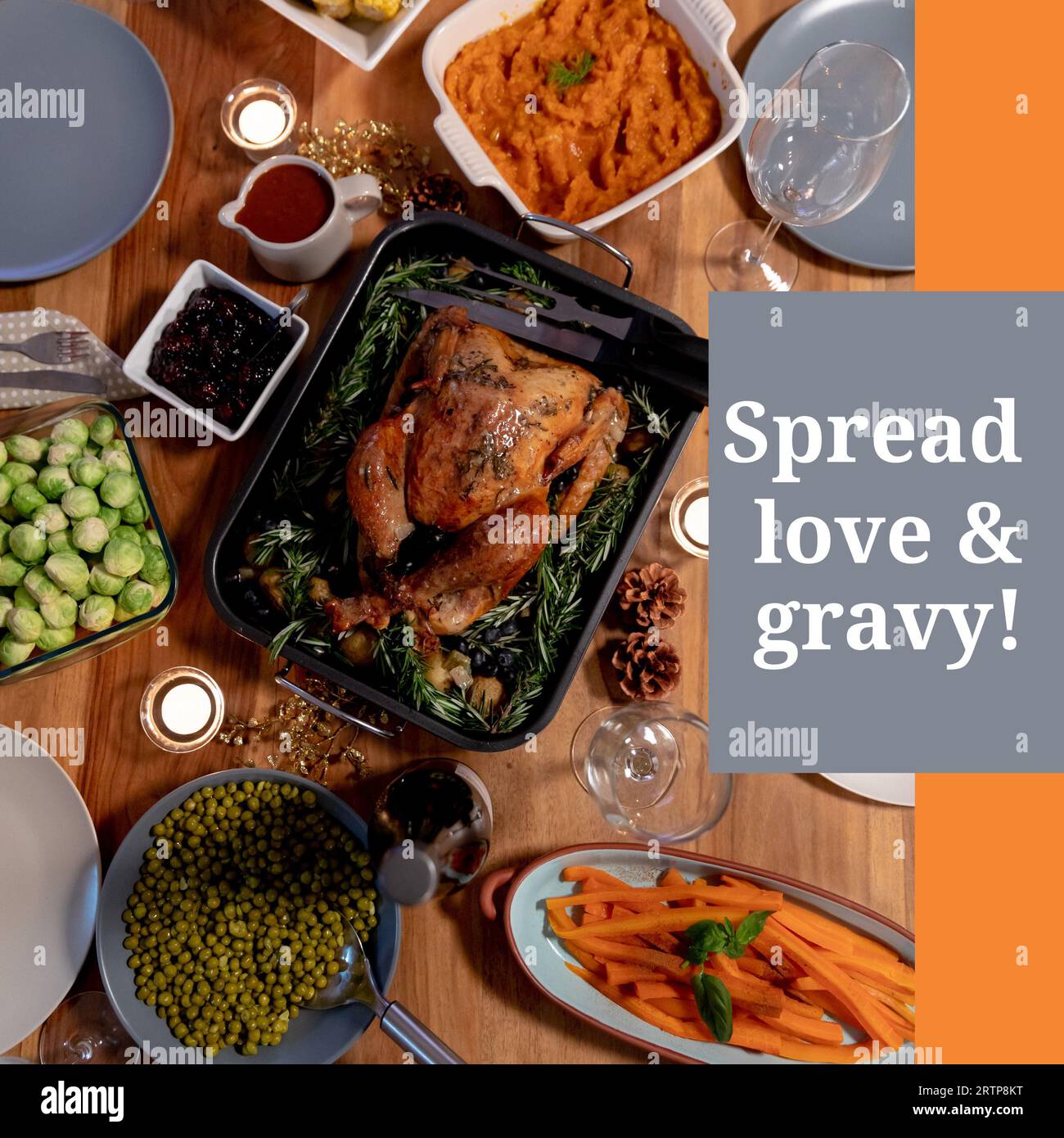 Spread love and gravy text on grey with thanksgiving dinner on table Stock Photo