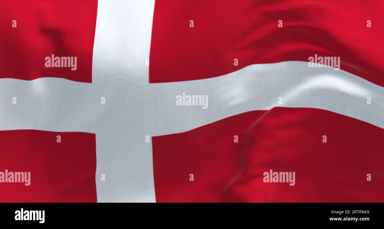 Denmark national flag waving on a clear day. Red flag with a white Scandinavian cross extending to the edge of the flag. 3d illustration render. Flutt Stock Photo