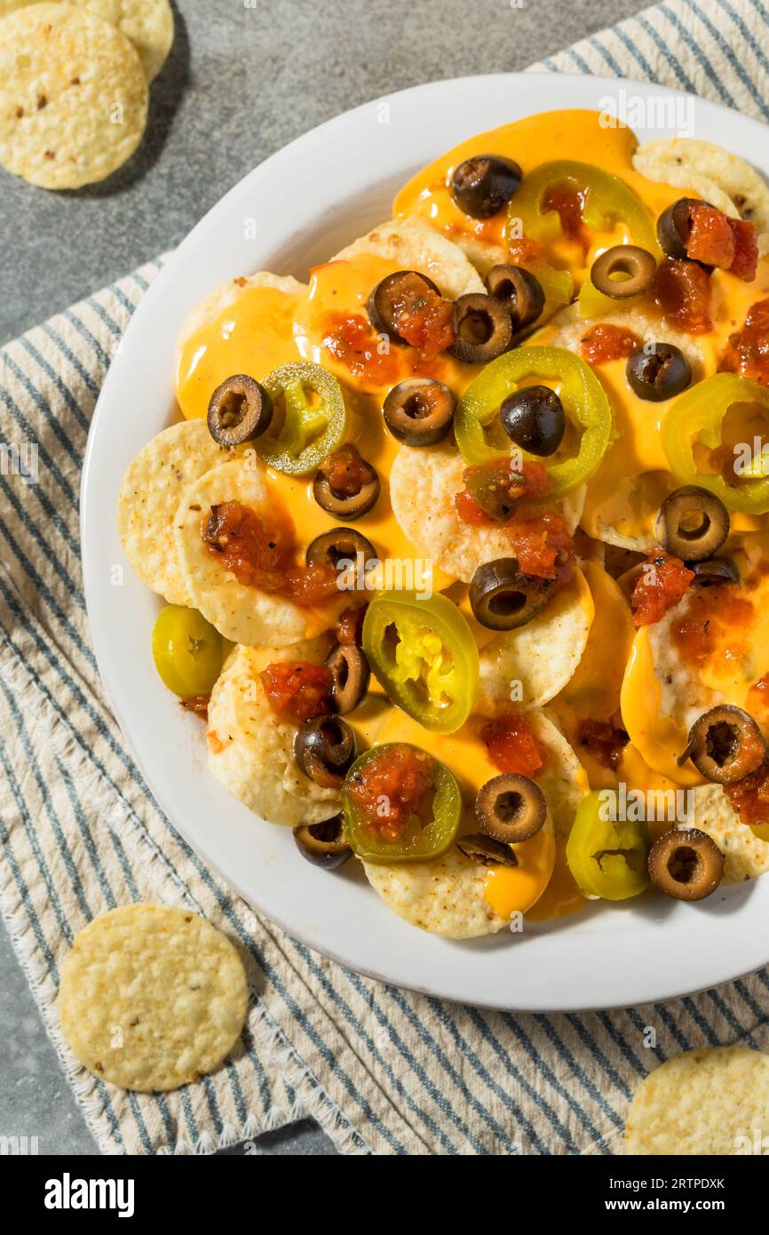 Homemade Basic Mexican Nachos with Cheese Jalapeno and Olives Stock