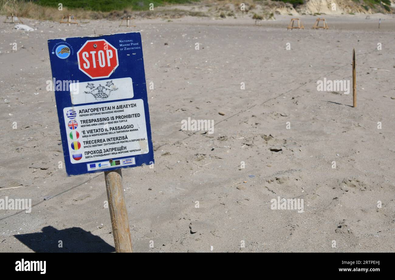 STOP sign in five different languages for the National Marine Park of Zakynthos on Kalamaki Beach Laganas Bay. Stock Photo