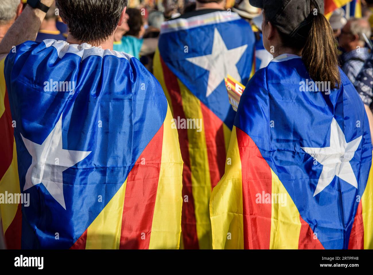 Barcelona, Catalonia, Spain - September 11, 2023: Young participants in the National Day of Catalonia demonstration wrapped in the independence flag w Stock Photo